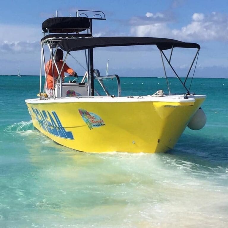 Bright yellow Captain Marvin's parasail boat on the water in Turks and Caicos
