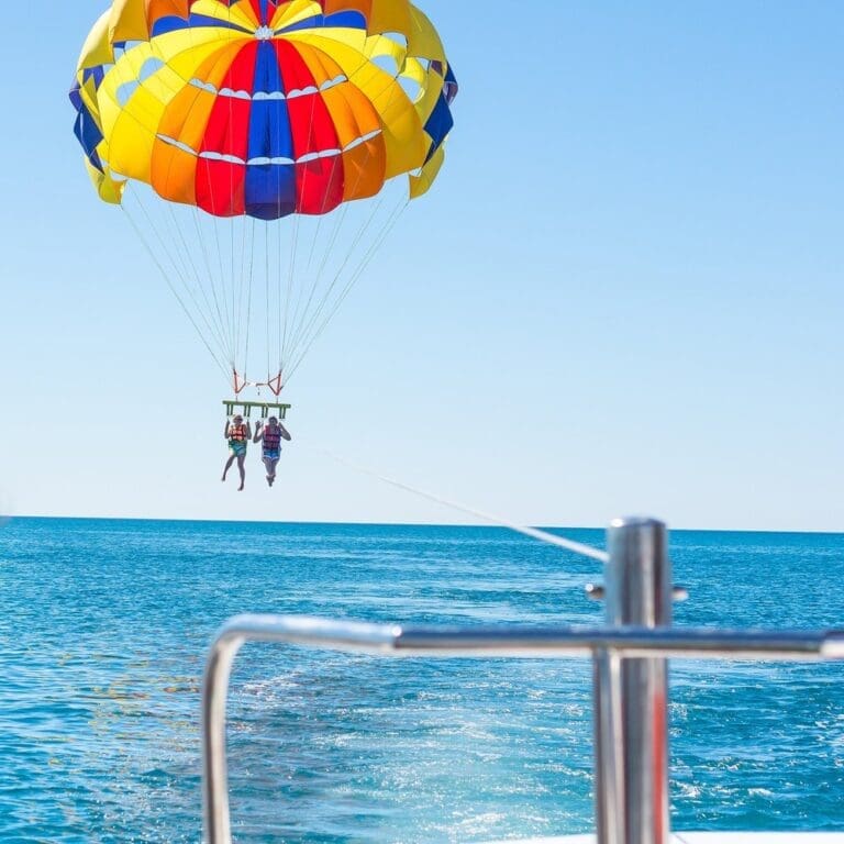 parasailing in Turks and Caicos over Grace Bay beach.