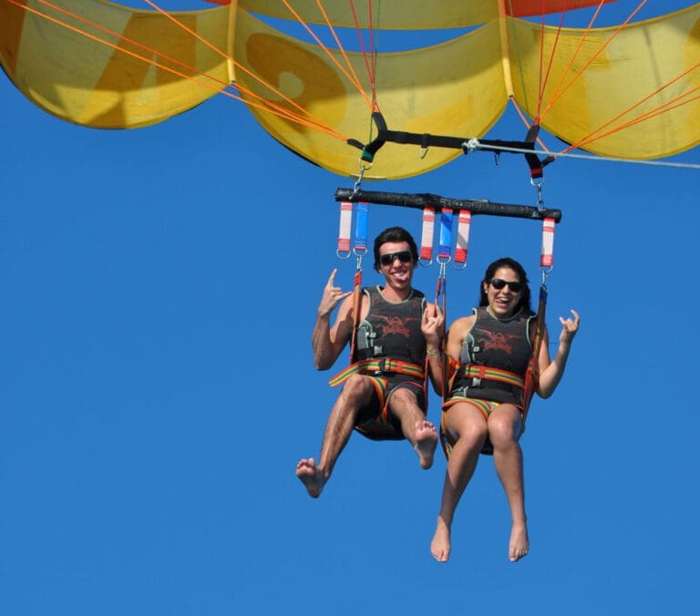Family parasailing over Grace Bay Beach, Turks and Caicos