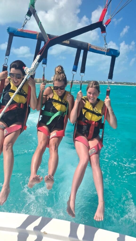 Family enjoying a parasailing boat trip in Grace Bay, Providenciales, Turks and Caicos with Captain Marvin's Watersports.